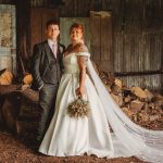 Bride and groom in rustic barn setting.