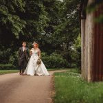 Bride and groom walking on a country path.