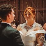 Bride and groom exchanging vows at wedding ceremony.