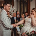 Bride and groom holding hands, wedding ceremony joyful moment.