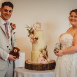 Bride and groom with wedding cake.