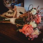 Wedding bouquet with roses on wooden table