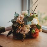 Colourful bouquet on wooden windowsill.