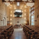 Rustic wedding venue with floral decorations.