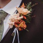 Boutonniere on suit jacket with floral tie