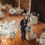 Bride and groom in rustic wedding venue.