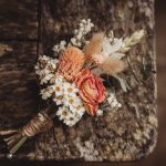 Rustic bouquet with dried flowers on wooden table.