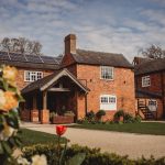 Charming brick house with solar panels and garden.