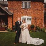 Bride and groom outside rustic brick building