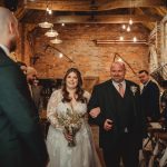 Bride walking down the aisle with her father.