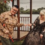 Happy couple playing mini-golf by the lakeside.