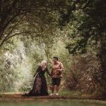 Couple walking through wooded path in nature