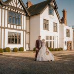 Bride and groom outside stylish country house