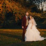 Bride and groom in autumnal forest setting