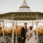 Couple in a gazebo during wedding ceremony.