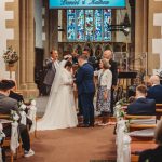 Couple exchanging vows in a church wedding ceremony.