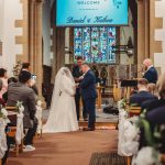 Wedding ceremony in a decorated church.