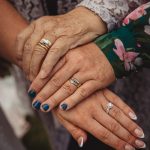 Hands with rings showing family generations bond.