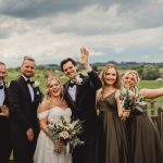 Group celebrating at outdoor wedding ceremony.