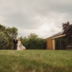 Couple walking in garden near modern building