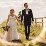 Wedding couple walking on countryside path