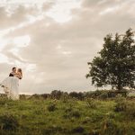 Bride and groom in scenic countryside wedding photo