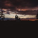 Silhouetted couple at sunset with dramatic sky