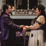 Couple holding hands during handfasting ceremony