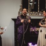 Couple tying the knot in handfasting ceremony.