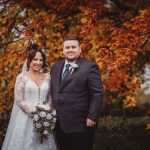 Bride and groom, autumn leaves background.