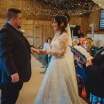 Wedding ceremony couple exchanging vows indoors.