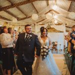 Bride and groom in a festive wedding hall.