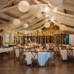 Elegant wedding reception with tables and string lights.