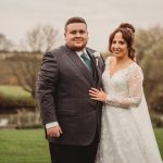 Bride and groom smiling outdoors on wedding day