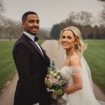 Bride and groom smiling outdoors on wedding day