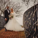 Bride and groom on decorated bridge