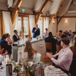 Wedding speech at reception dinner in elegant venue.