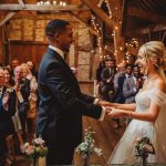 Couple exchanging vows in rustic wedding ceremony.