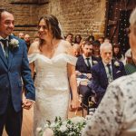 Wedding couple holding hands during ceremony