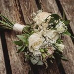 White rose bouquet on wooden bench