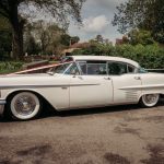 Vintage white car parked on country road