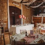 Rustic wedding reception with decorated tables.