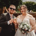 Bride and groom toasting at outdoor wedding