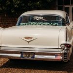 Vintage white Cadillac with rear view.