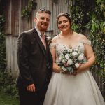 Bride and groom smiling in garden