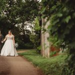 Bride and groom walking in garden