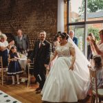 Bride and groom enter reception to applause