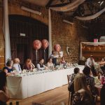 Wedding reception speech in rustic venue