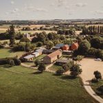 Aerial view of countryside village and fields.