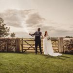 Newlyweds celebrating with champagne outdoors